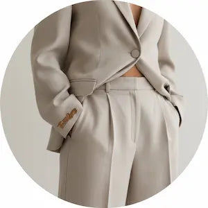 Beige trench coat on a light gray background.