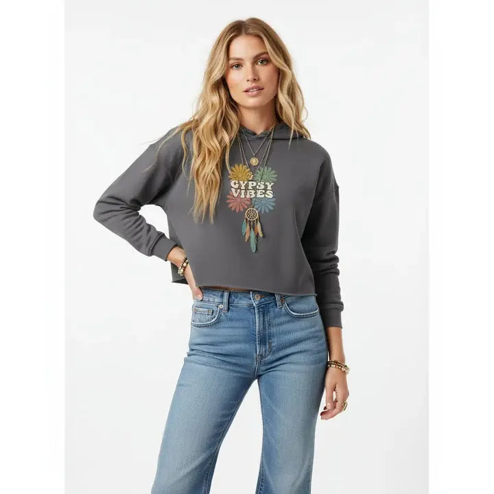 Woman wearing a gray hoodie with 'Gypsy Vibes' design and blue jeans on a white background.